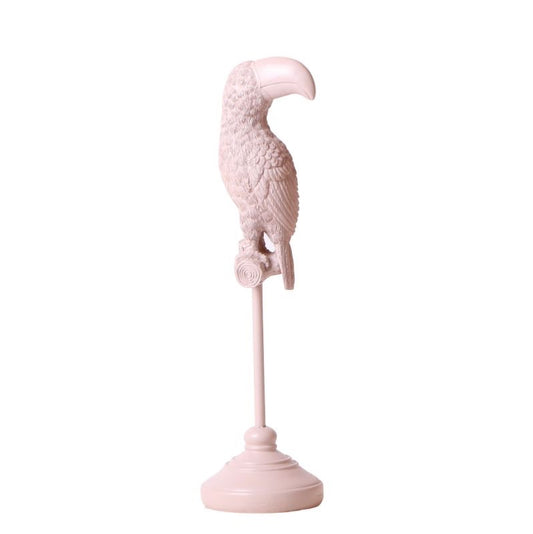 beeld van een nude kleurige toekan op stokje