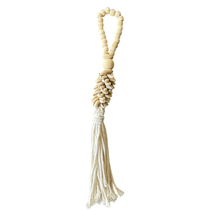Handgemaakte schelpenhanger met houten kralen en katoenen tassel uit Bali